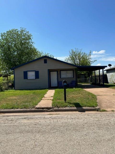 a front view of a house with a yard and a garage