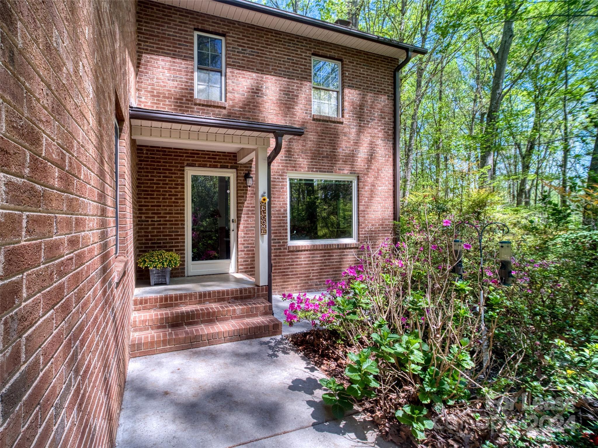 a front view of a house with plants