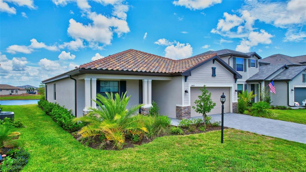 a front view of a house with a garden