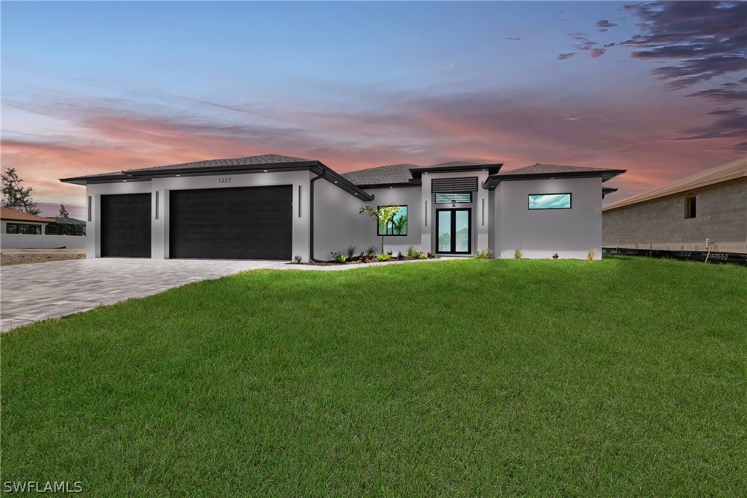 a front view of a house with a yard and garage