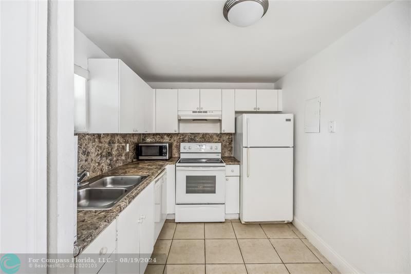 a kitchen with a sink cabinets and stainless steel appliances