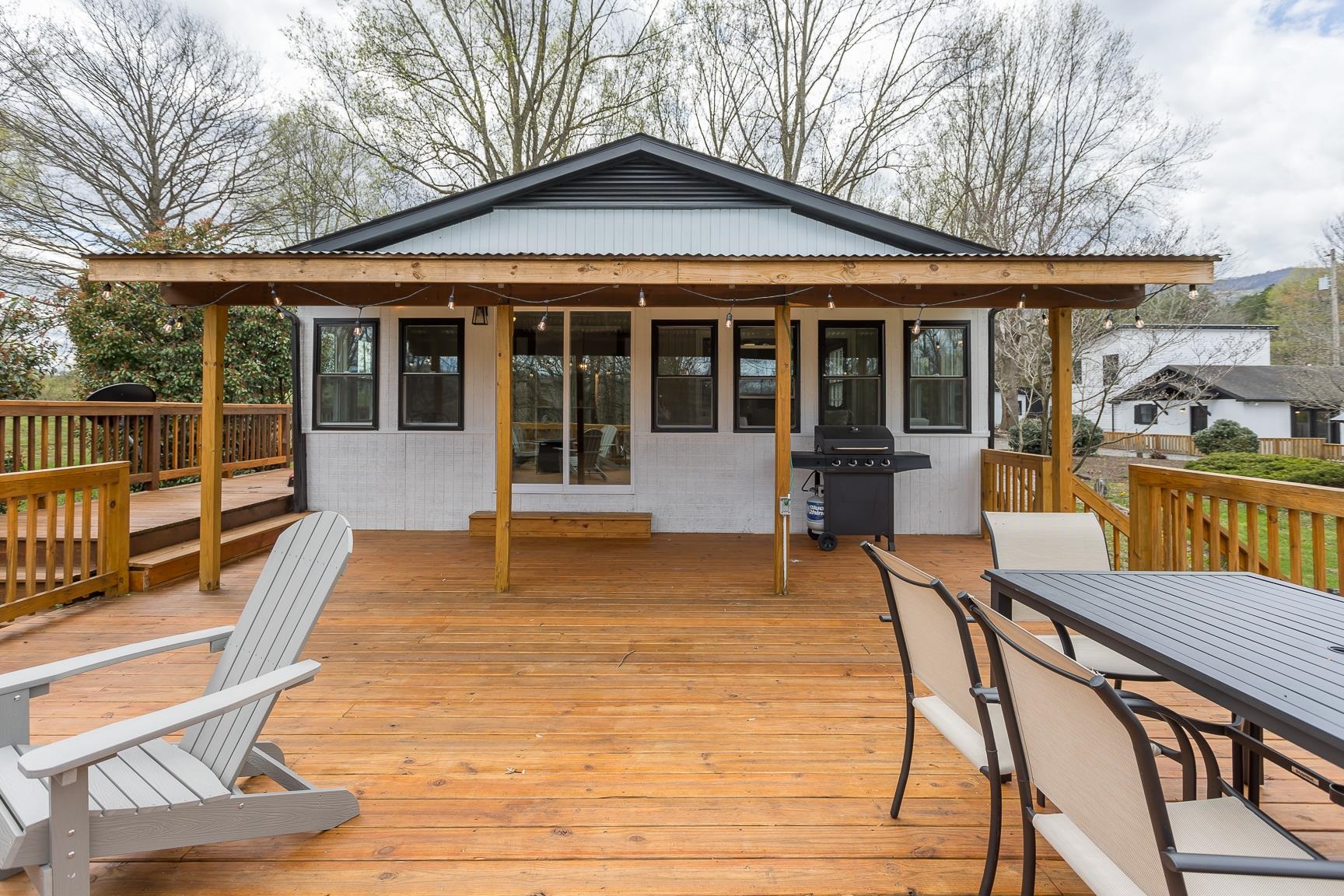 a view of a house with backyard patio and deck