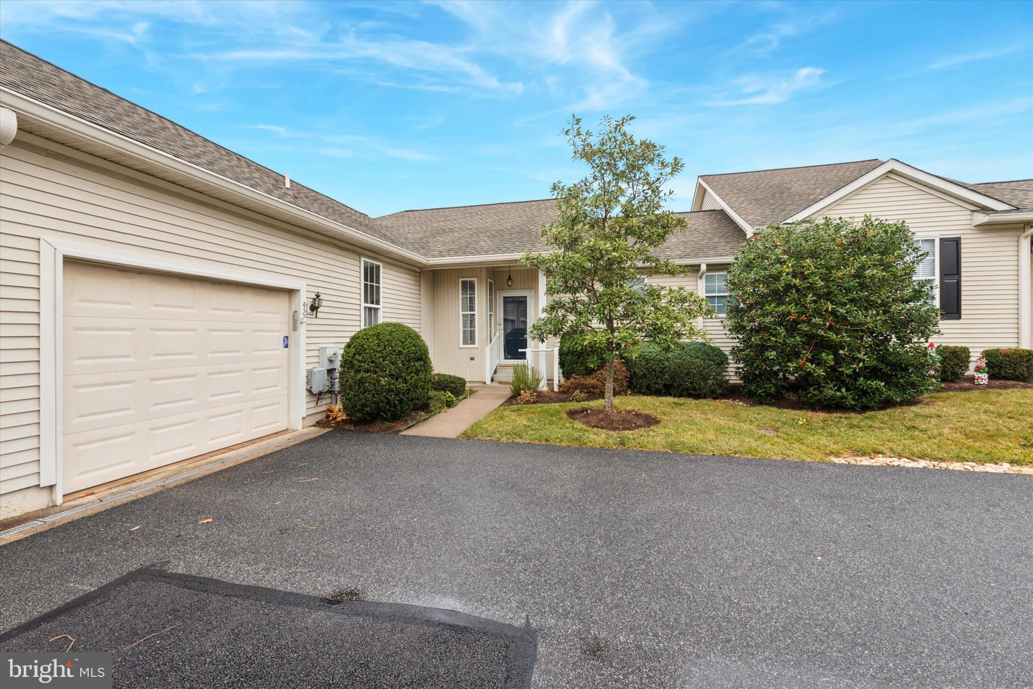 a view of a house with a yard and garage