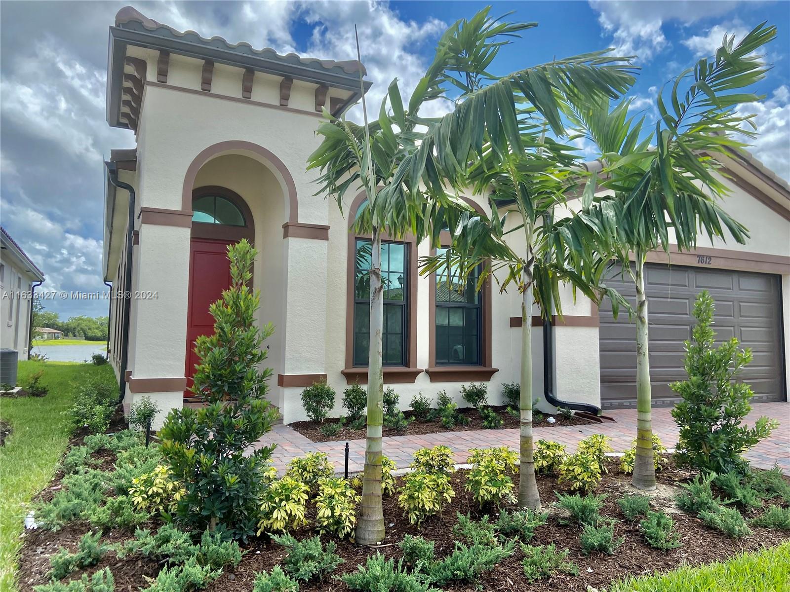 a front view of a house with plants