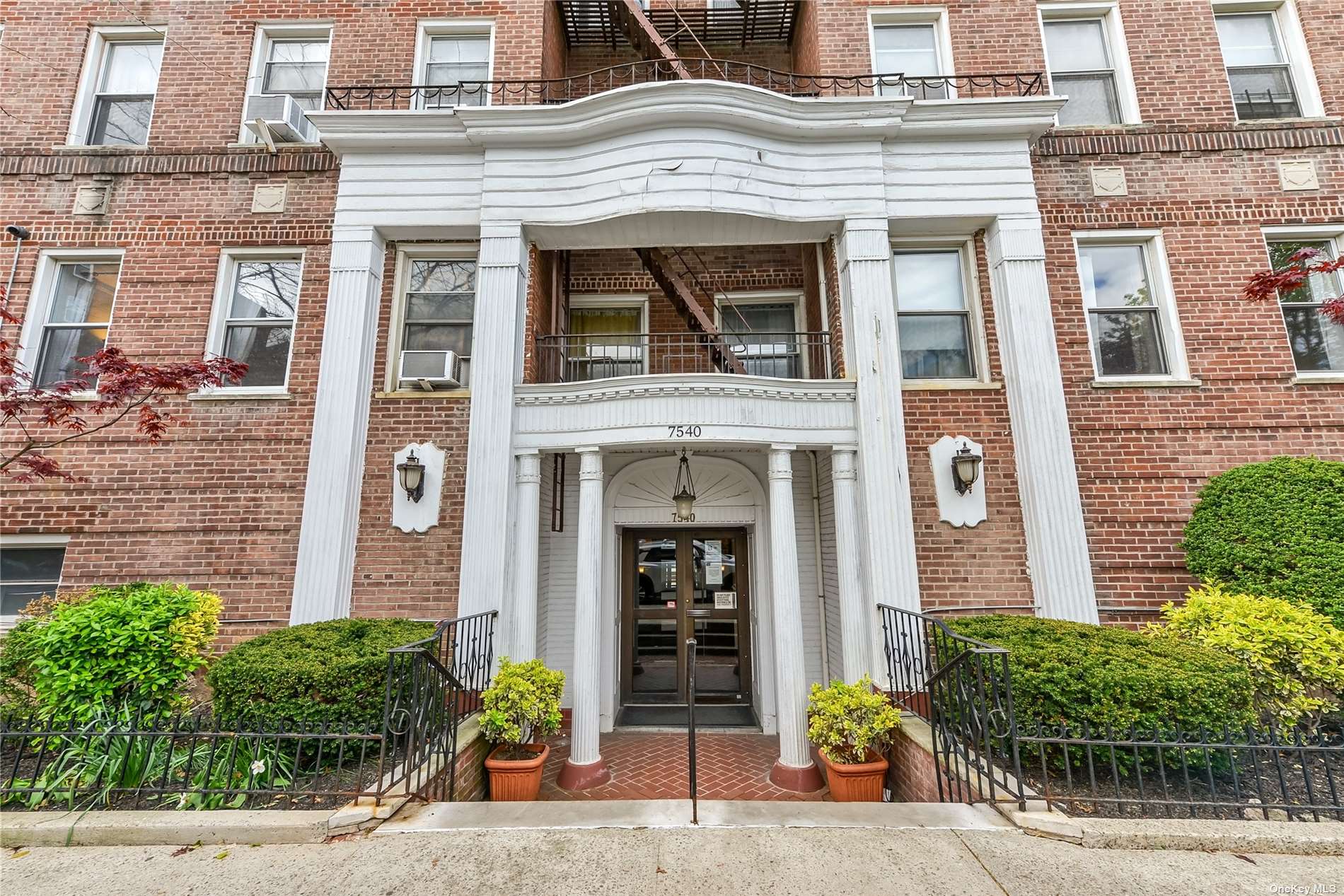 a view of a building with a potted plant in front of a building