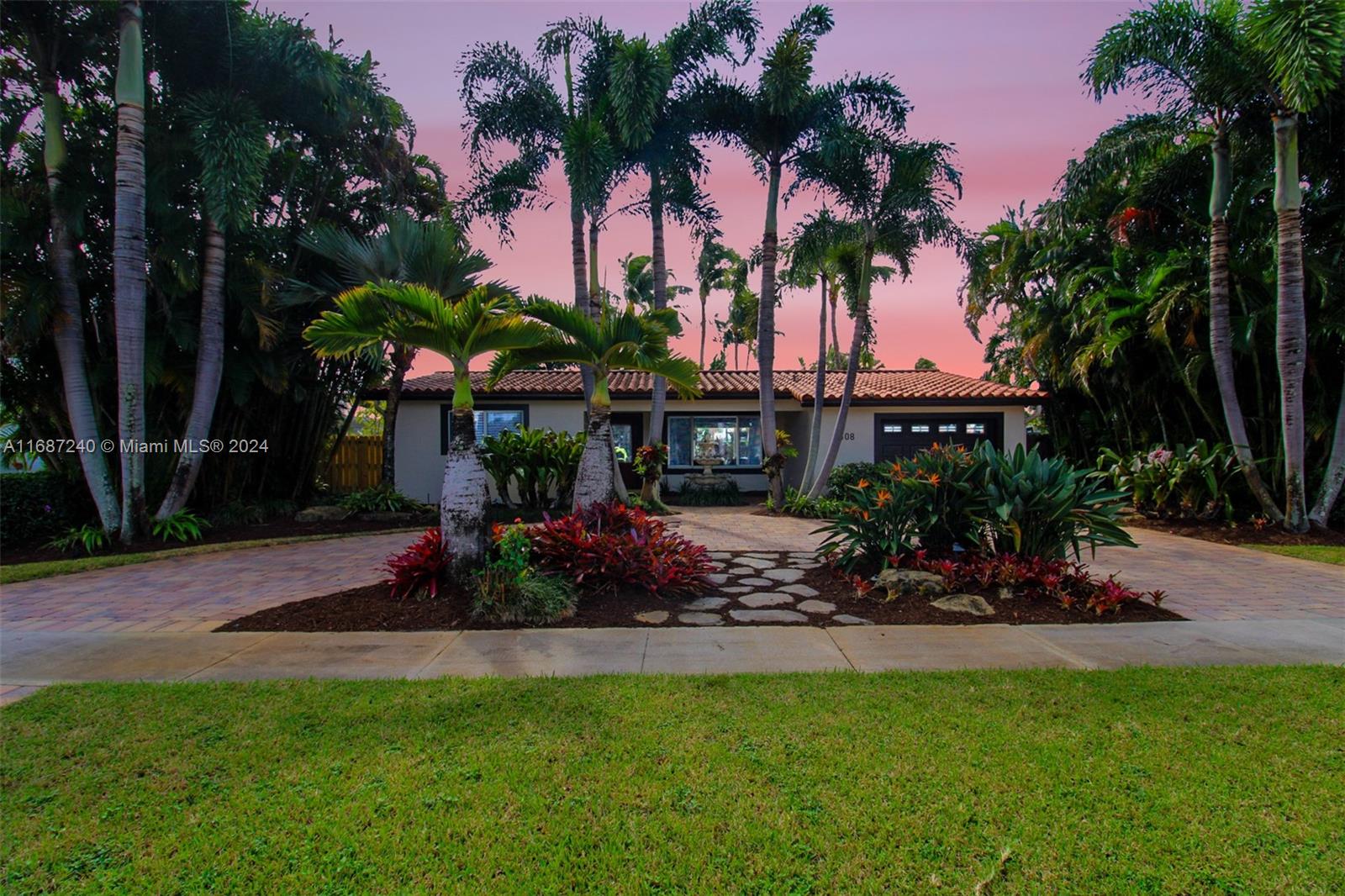 a view of a house with a swimming pool and sitting area