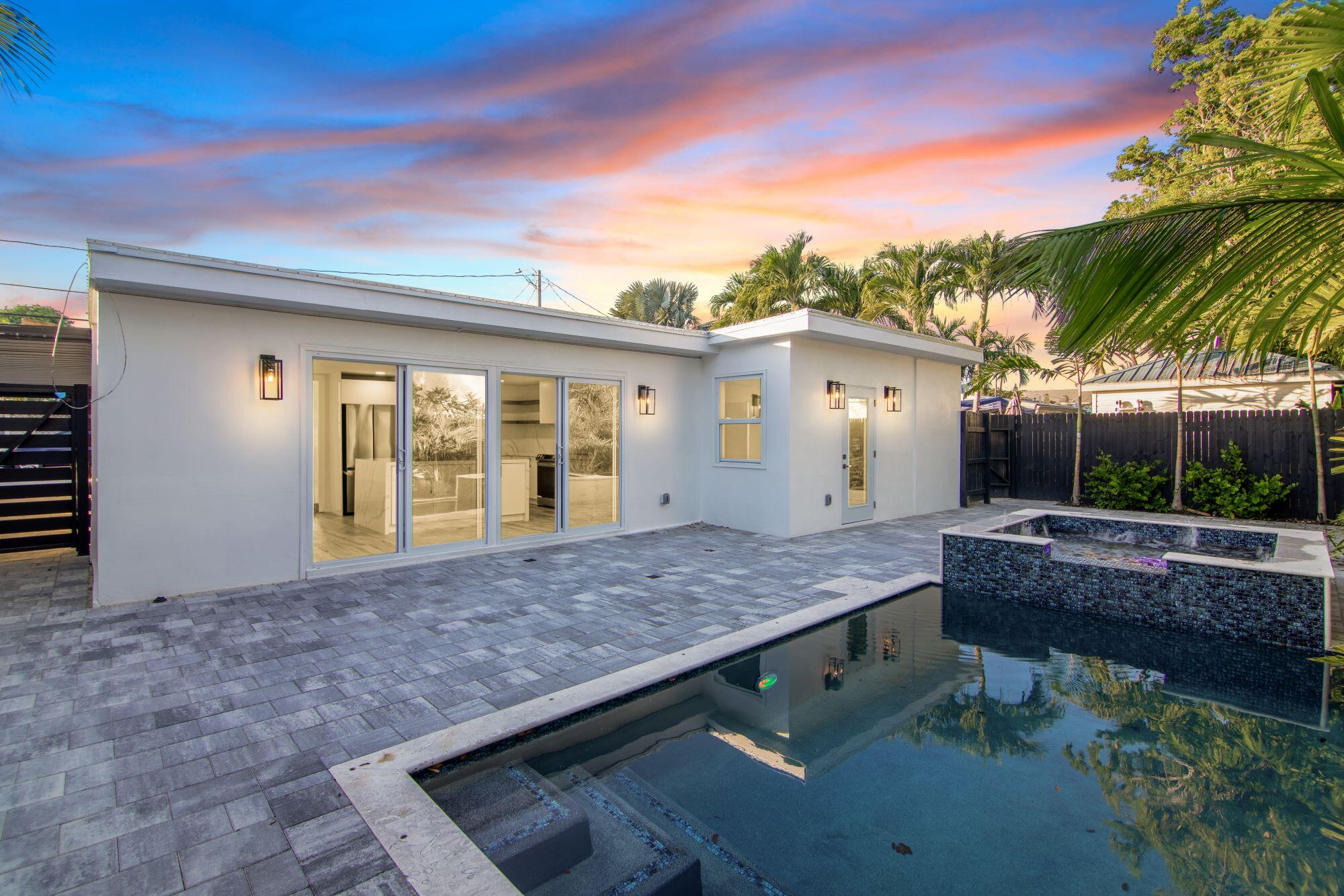 a view of house with backyard and outdoor seating