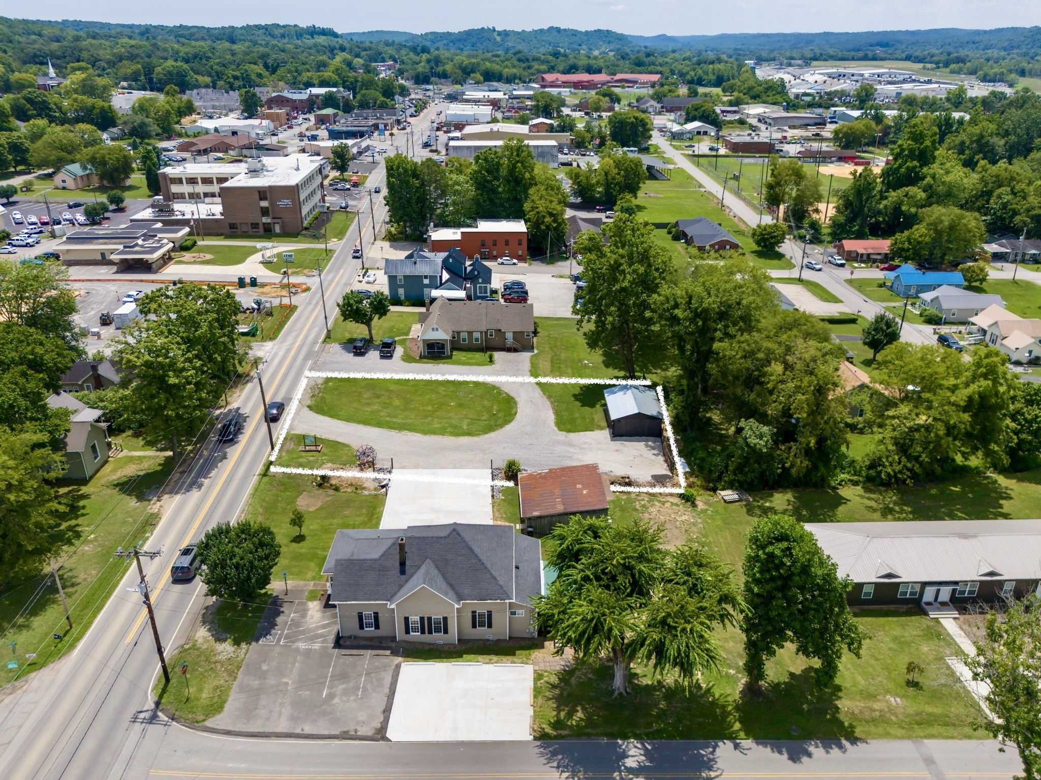 an aerial view of a house with a swimming pool yard and mountain view in back