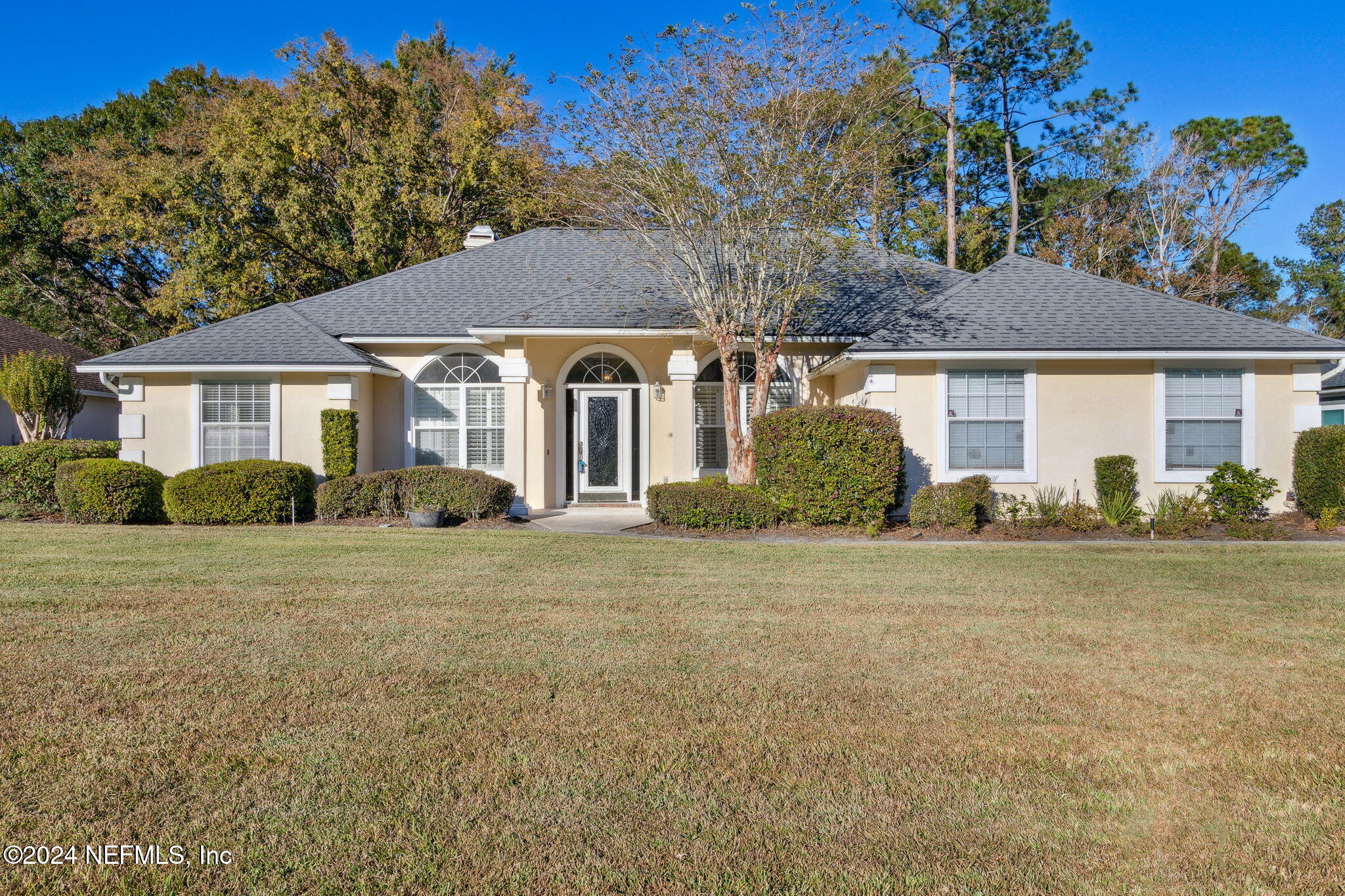 a front view of a house with a garden