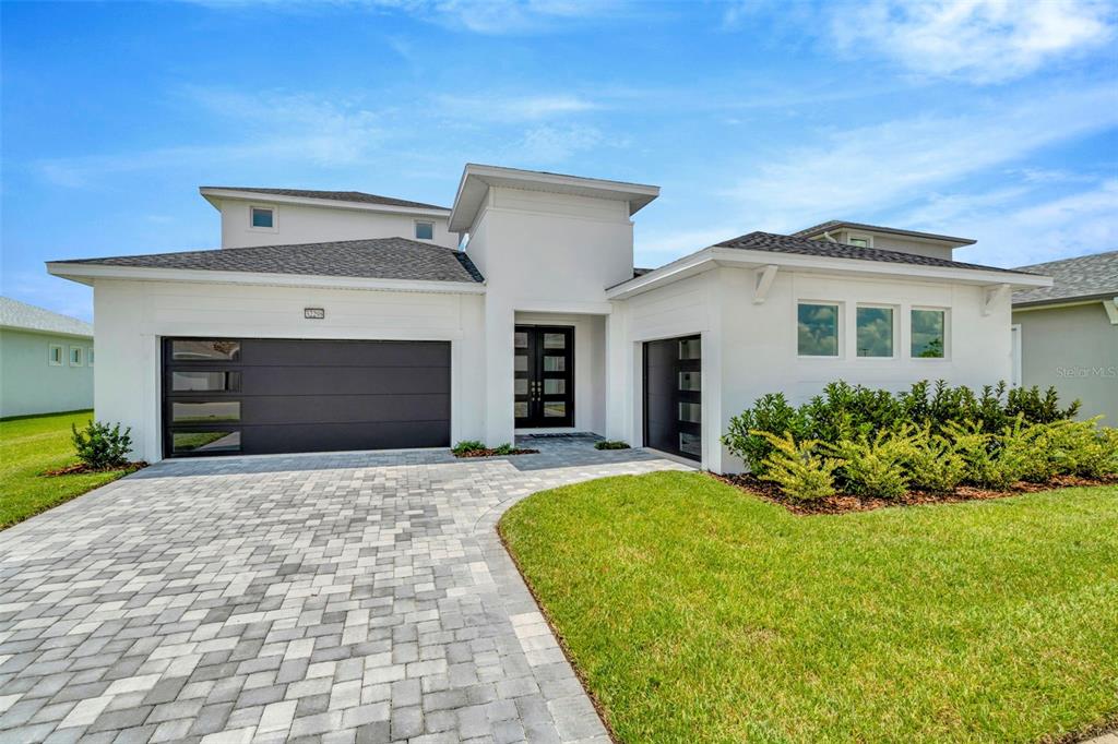 a front view of a house with a yard and garage