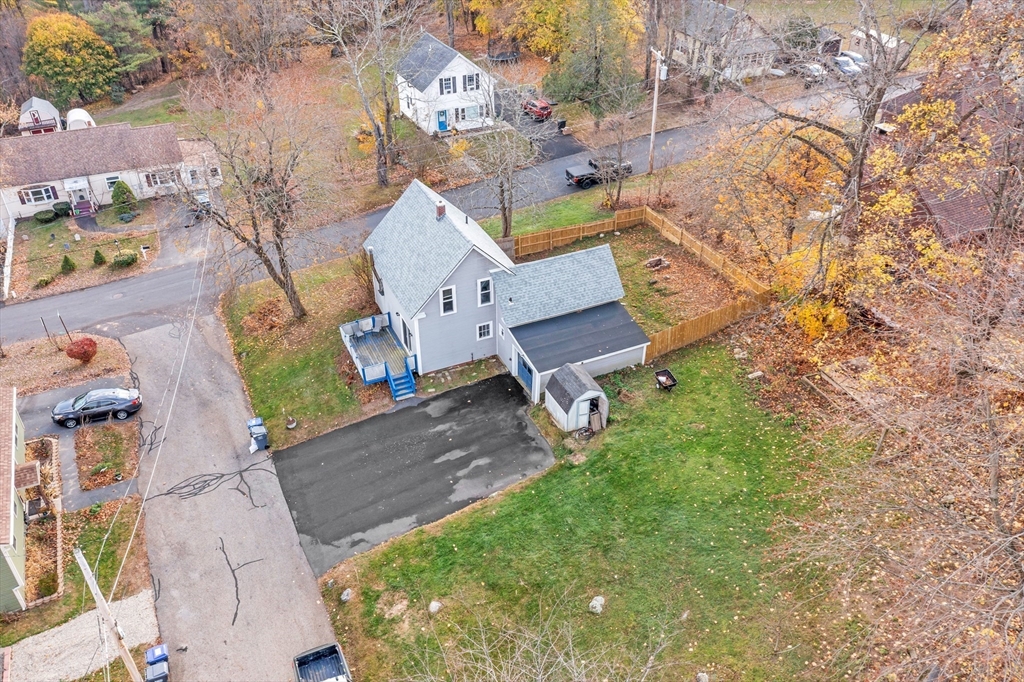 an aerial view of a house with garden space and street view