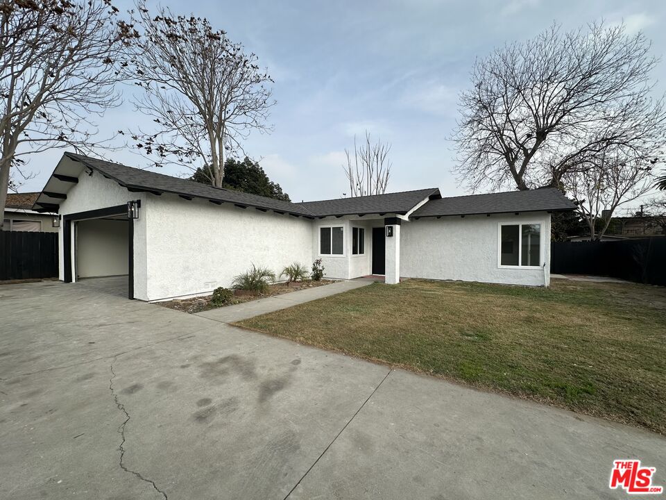 a view of a house with a outdoor space and a tree