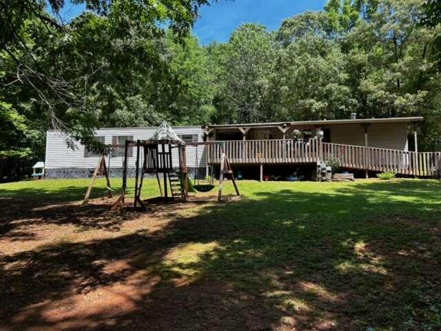 a view of a house with backyard and sitting area