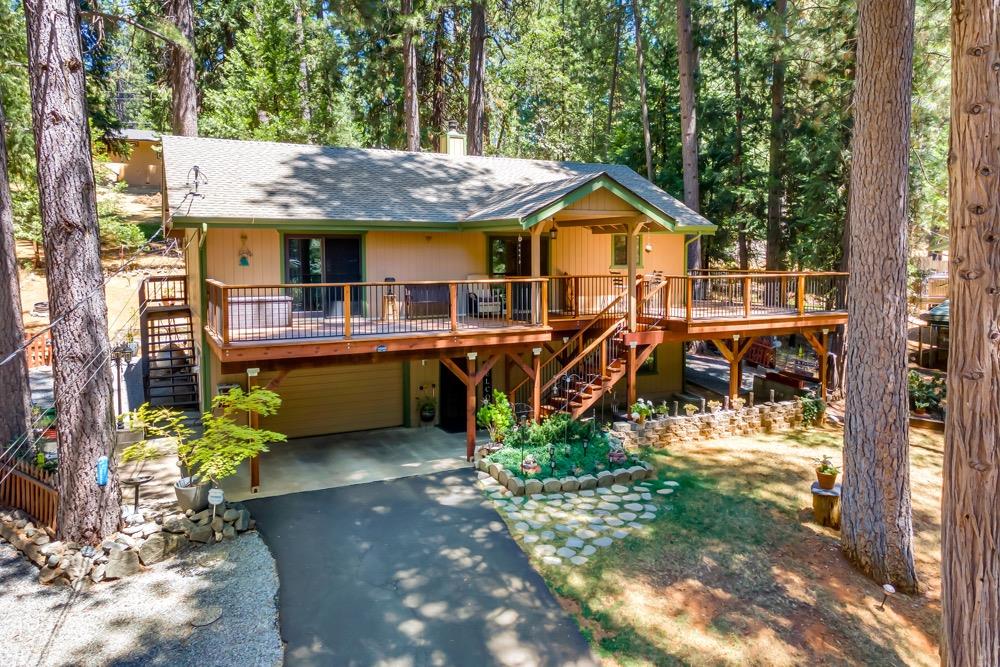 a view of a house with wooden deck and sitting area