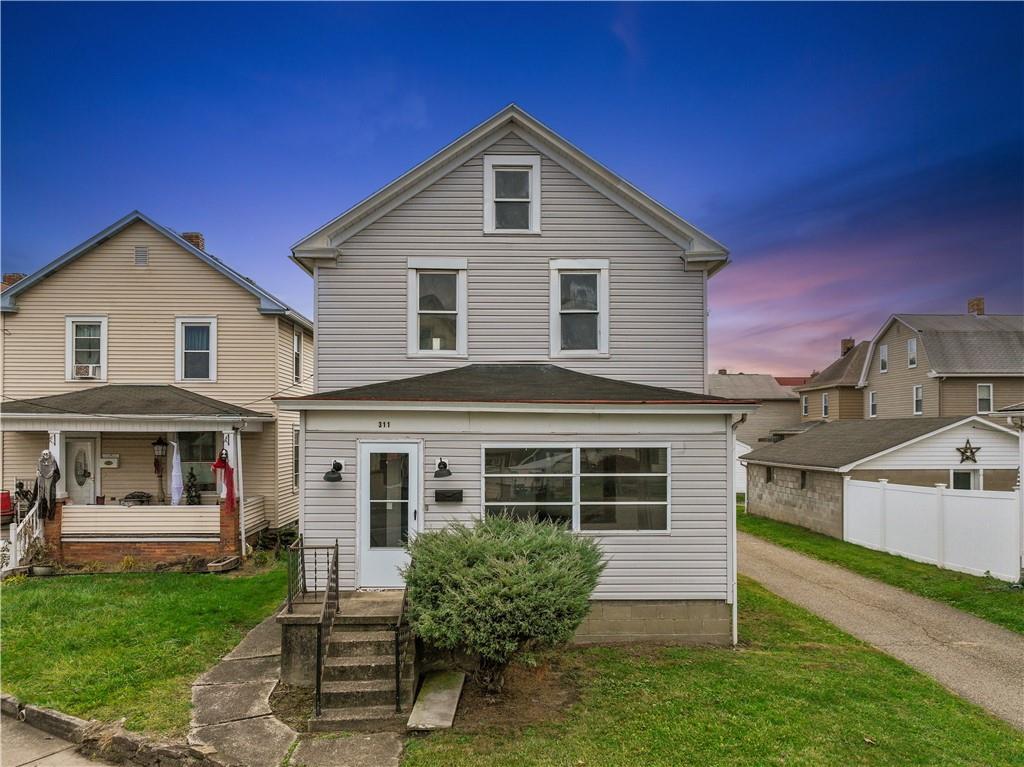 a front view of a house with a yard