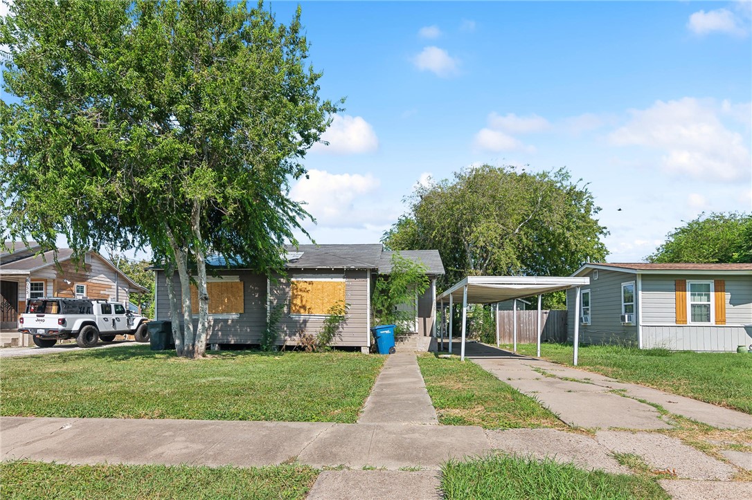 a view of house with outdoor space and garden