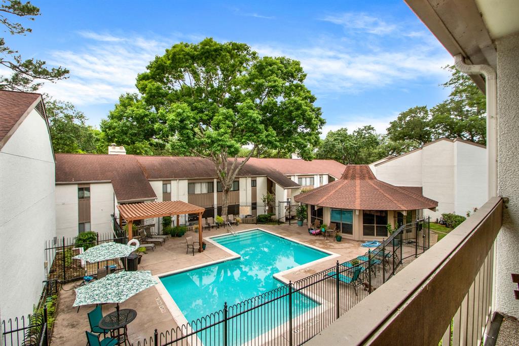 an aerial view of a house with swimming pool garden and patio