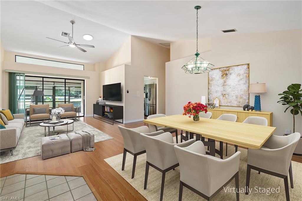 VIRTUALLY STAGED Open Dining room - Living Room with soaring vaulted ceiling, light hardwood / wood-style floors, Opening up to Florida Room