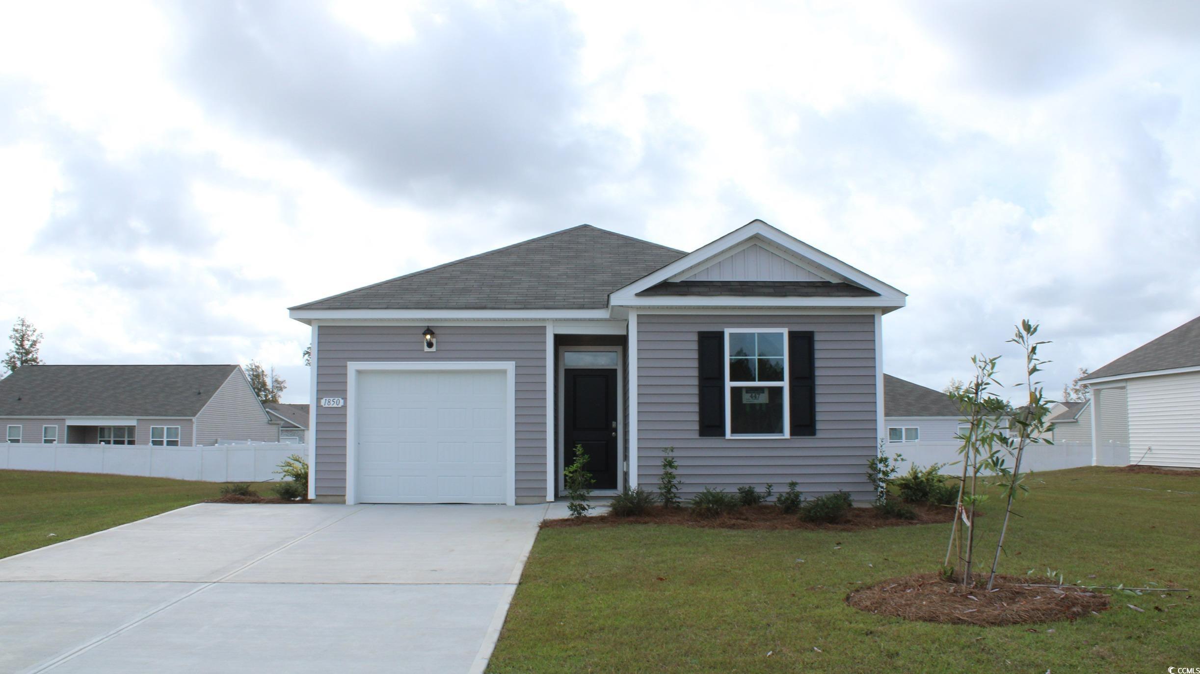 View of front of property featuring a front lawn a