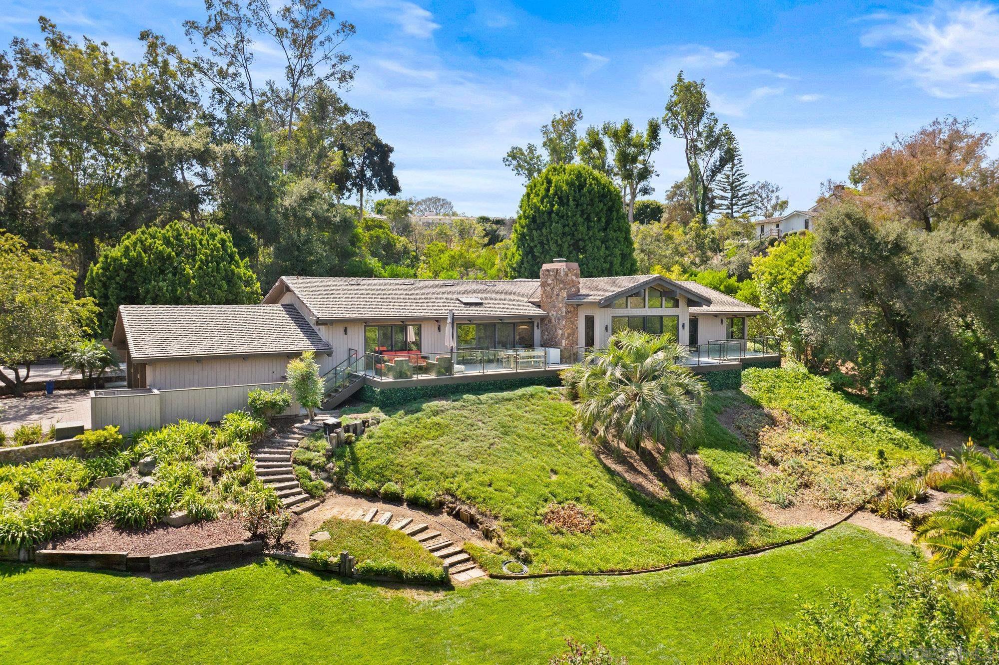 an aerial view of a house with a yard table and chairs