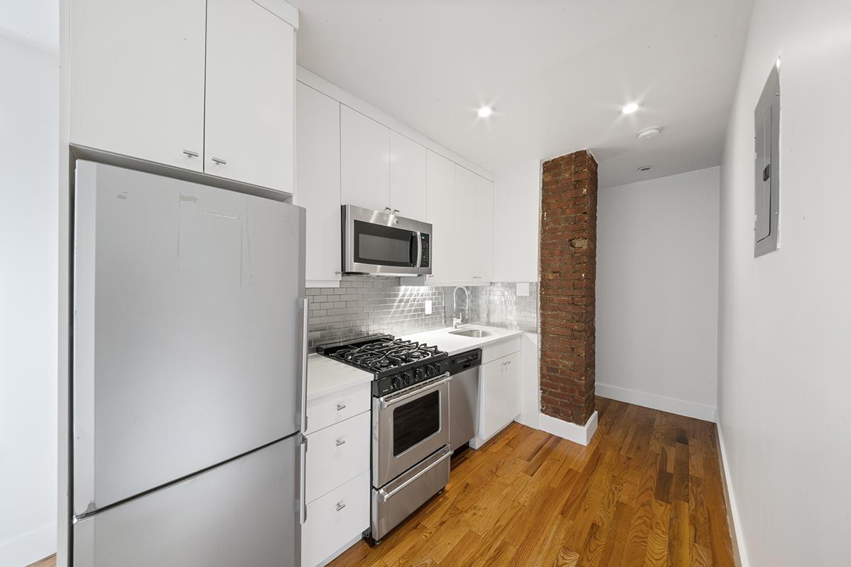 a kitchen with a sink and a refrigerator