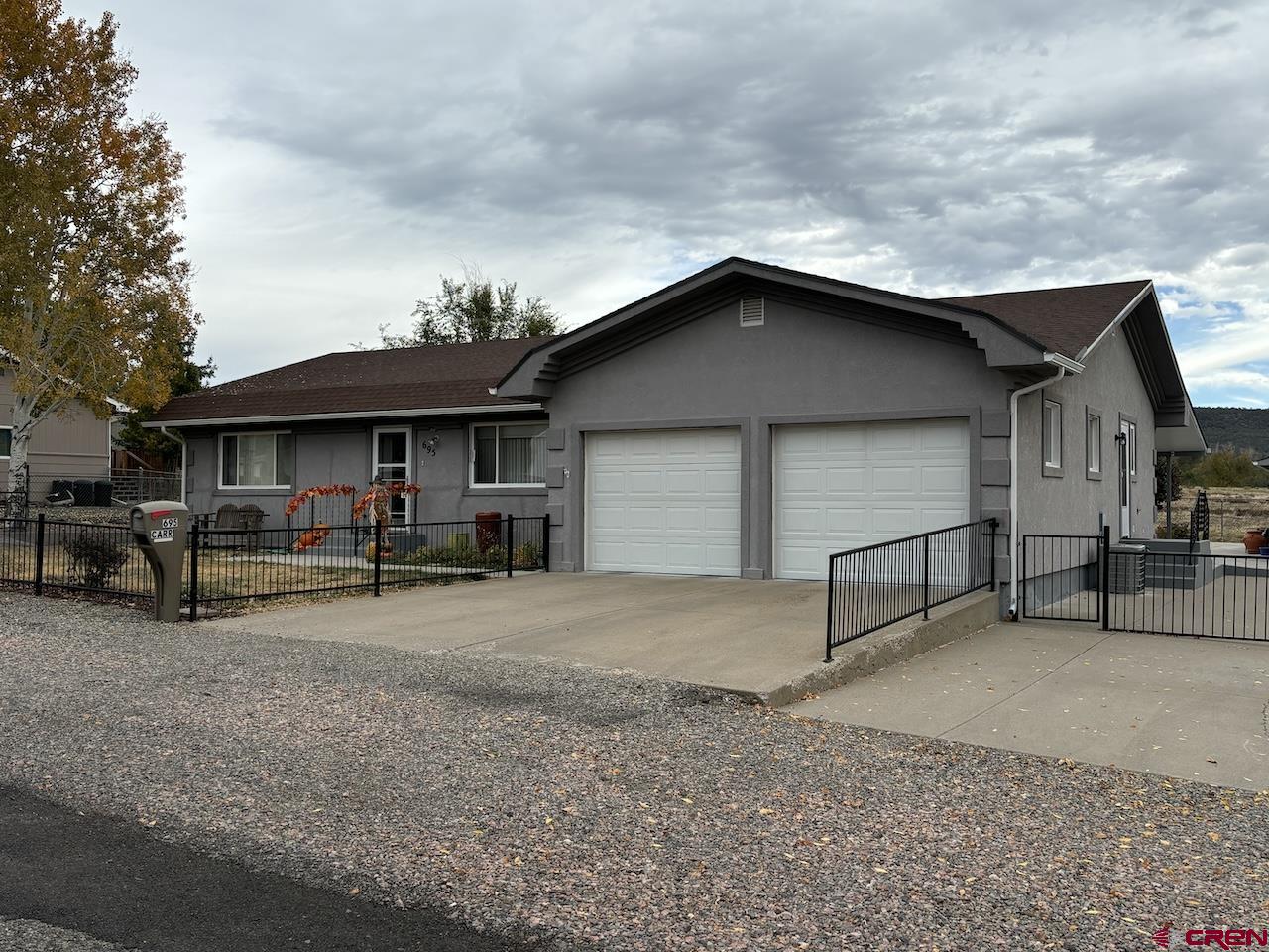 a view of a house with a patio and a yard