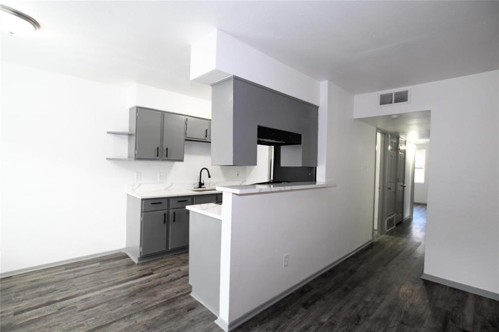 a kitchen with a sink and a stove top oven