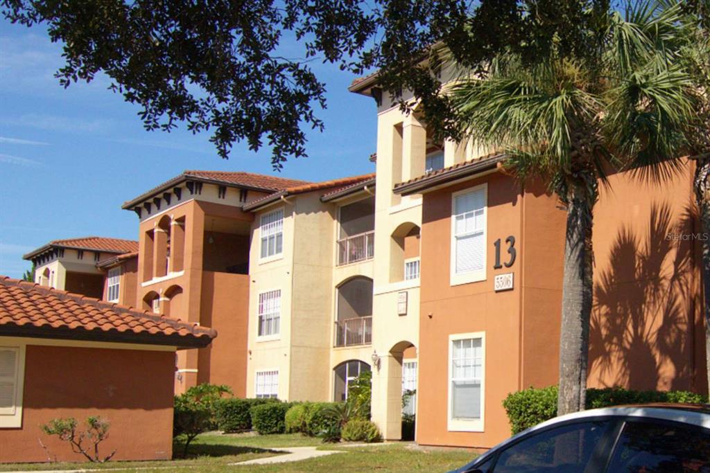 a front view of a residential apartment building with a yard