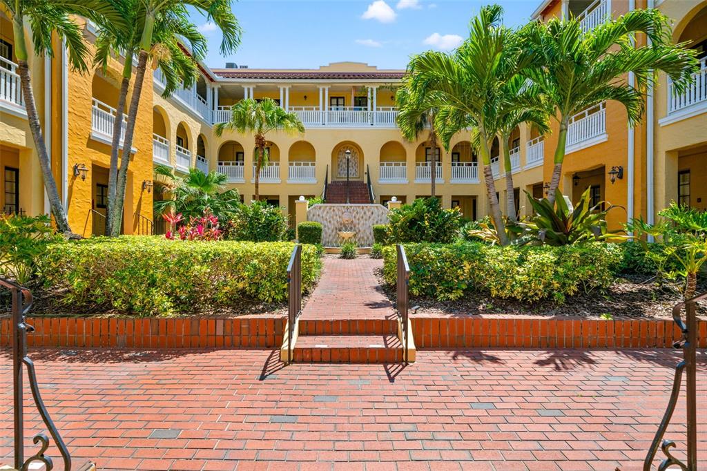 Mediterranean Revival courtyard + lush landscaping