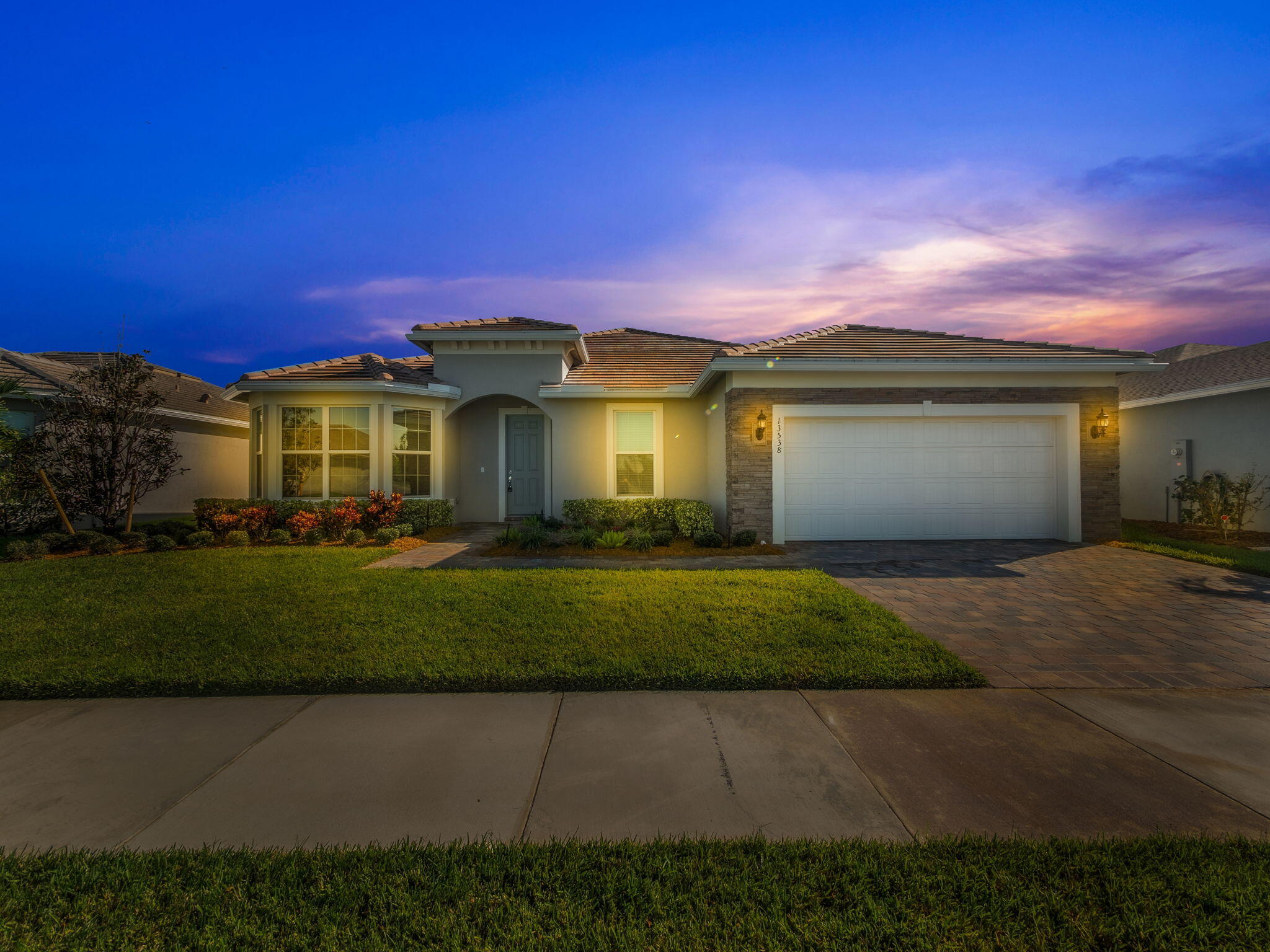 a front view of a house with a yard and a garage