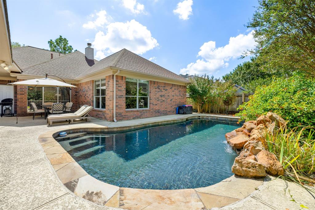 a view of a house with swimming pool and sitting area