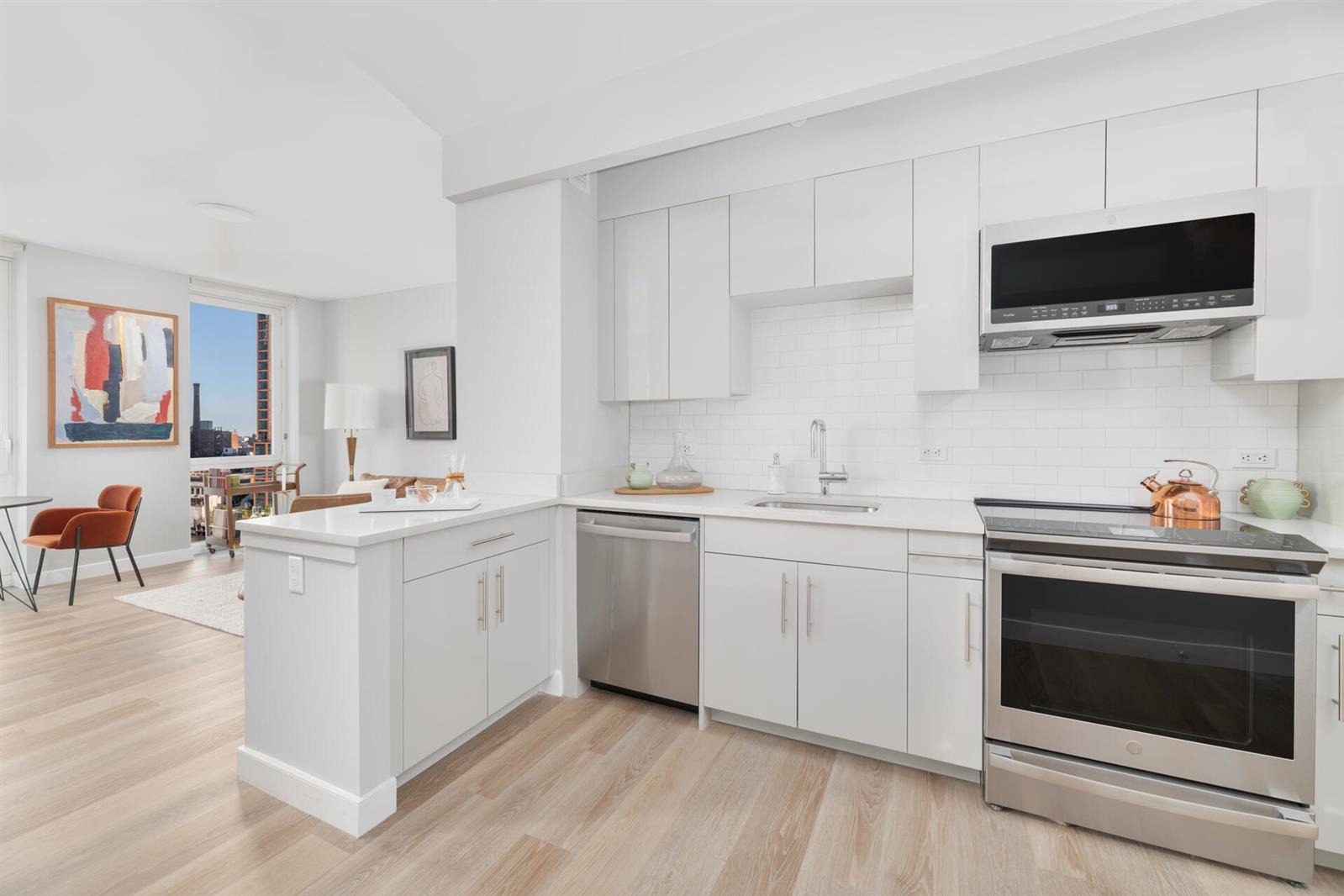 a kitchen with a sink stove and microwave