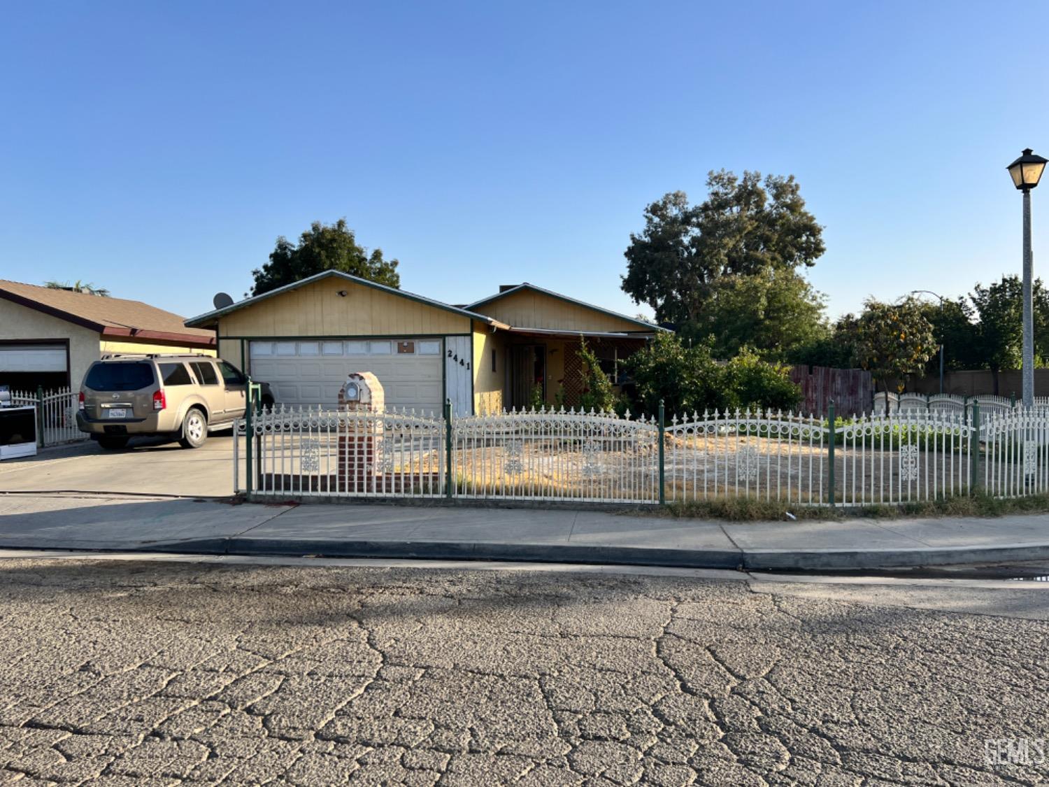 a front view of a house with a fence