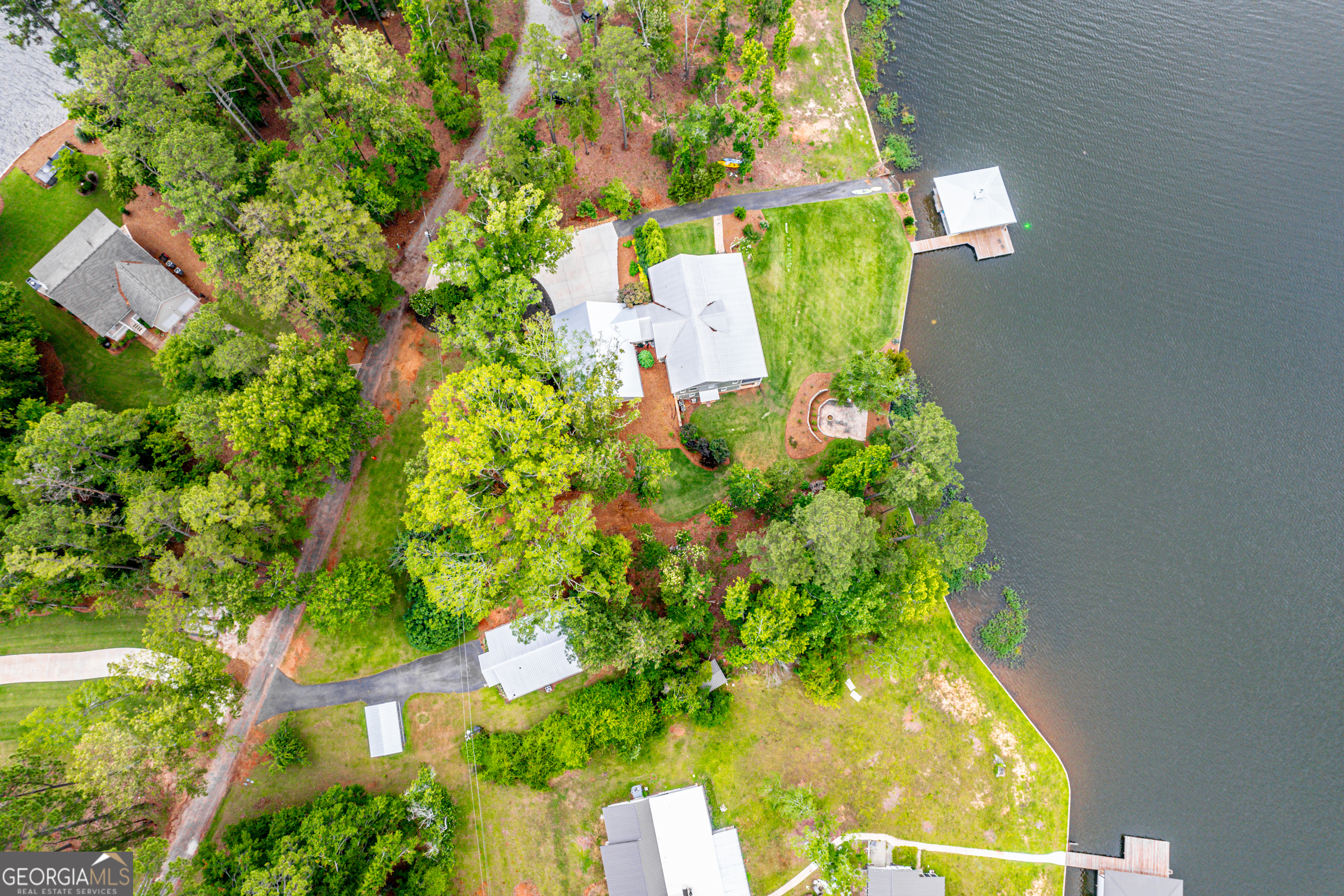 an aerial view of a residential houses with yard