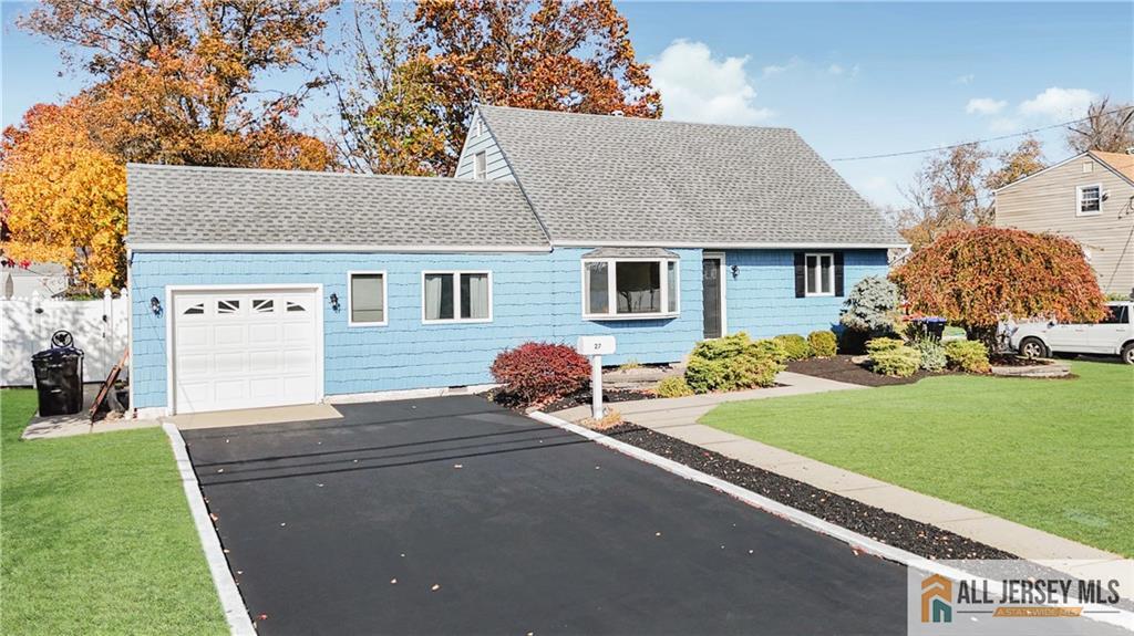 a front view of a house with a garden and yard