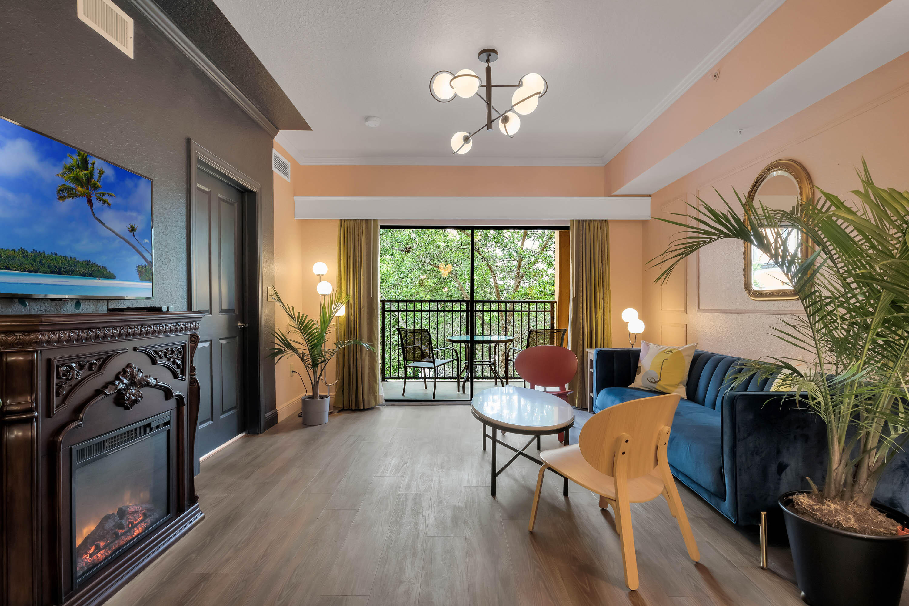 a living room with furniture a fireplace and a flat screen tv