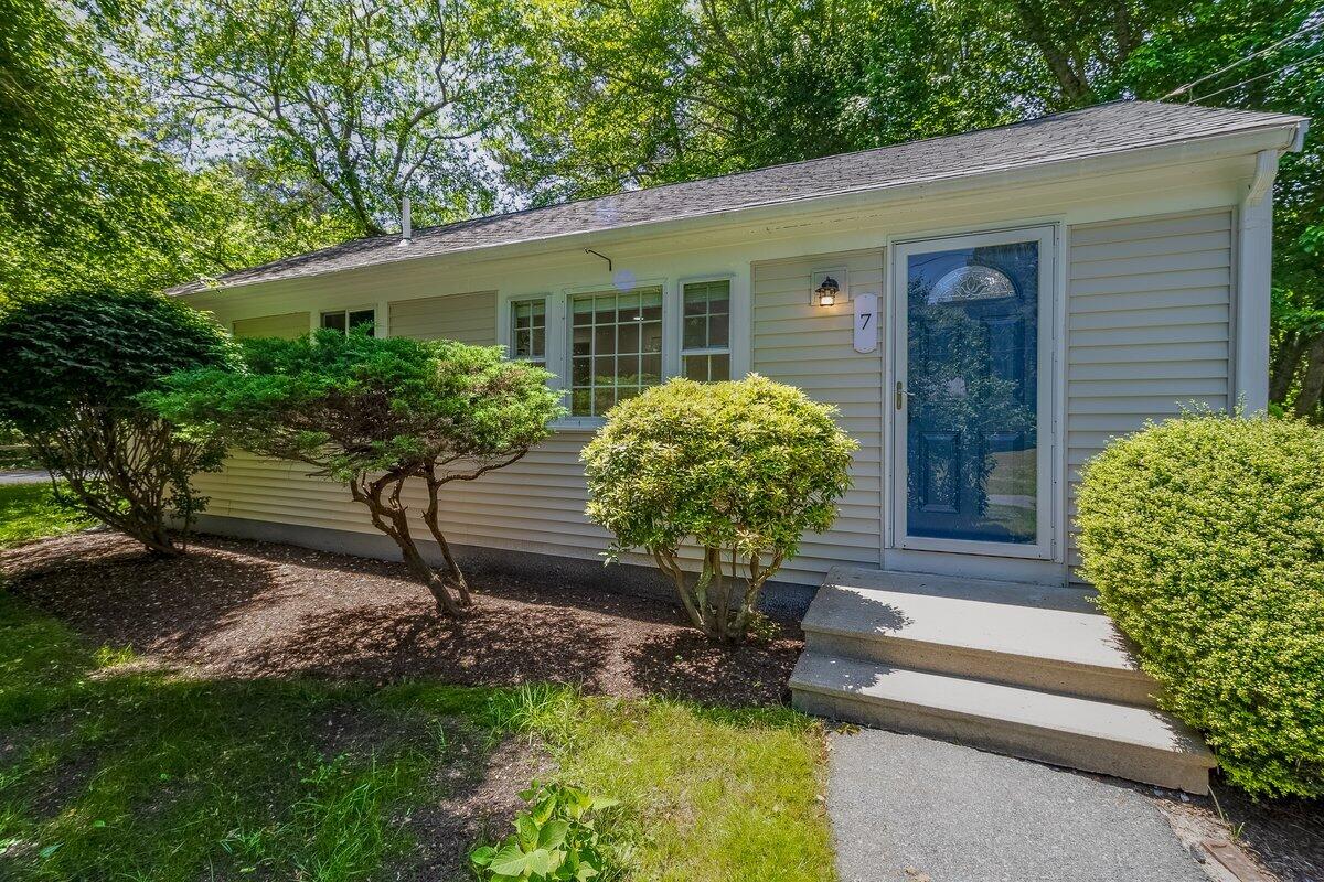 a front view of house with a garden and patio