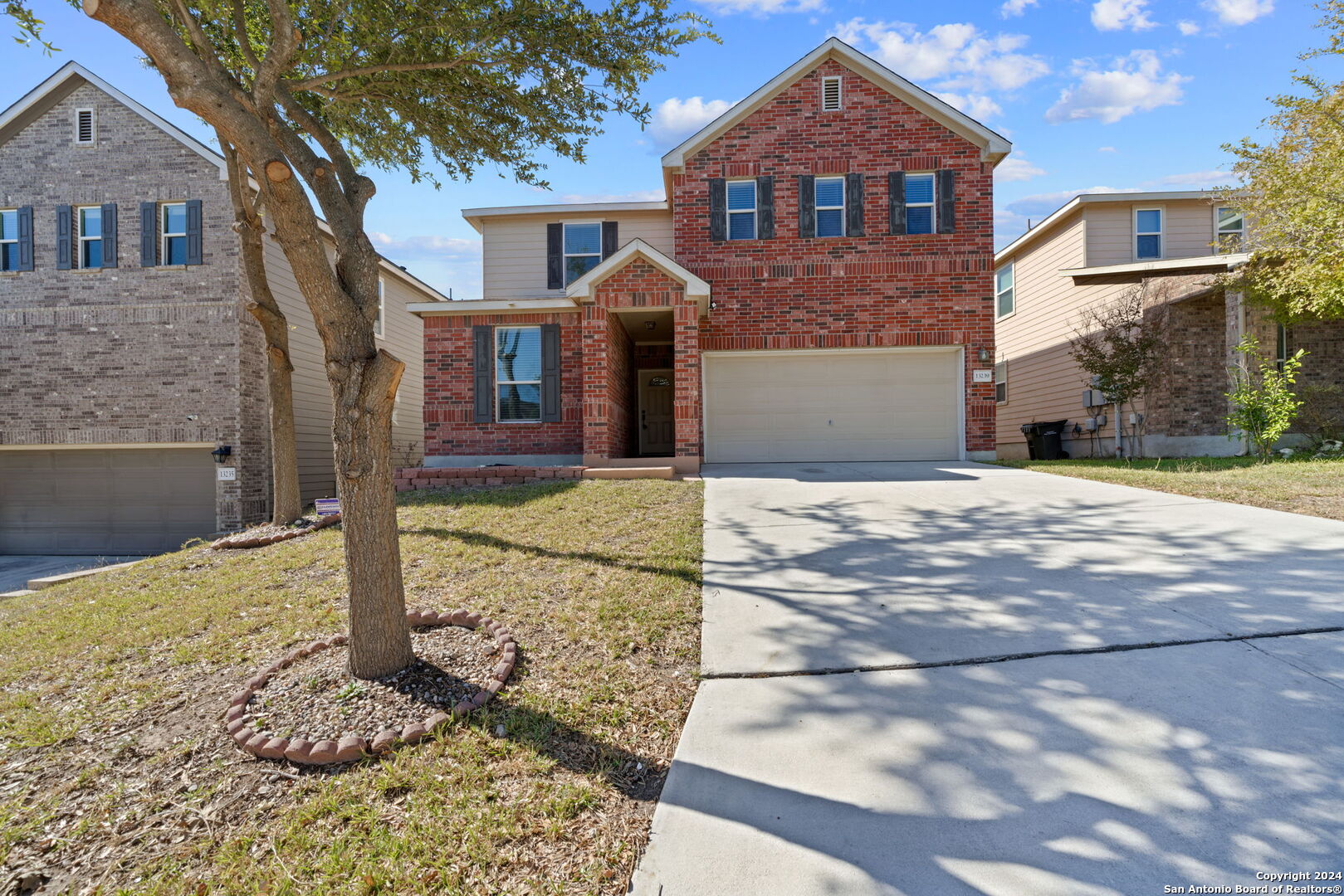 a front view of a house with a yard