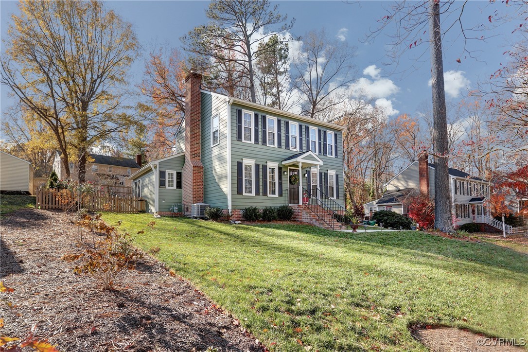 View of front of house with central AC unit and a