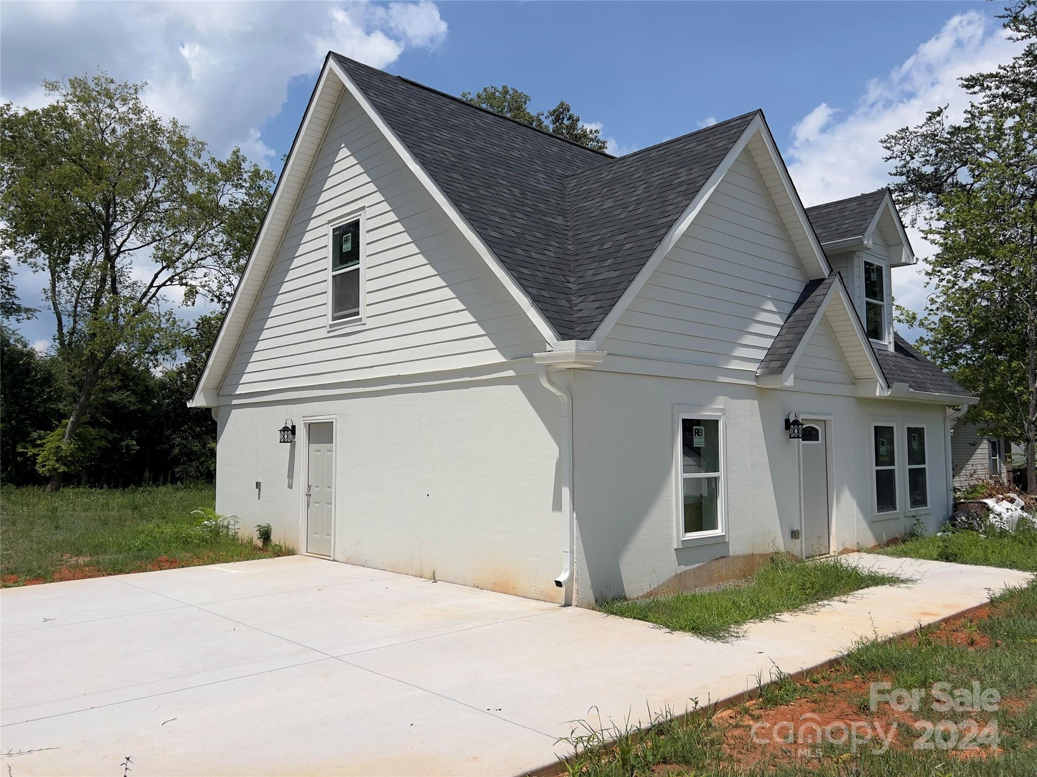 a view of house with backyard space and garden