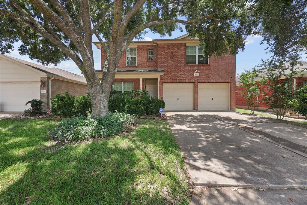 a view of a house with a tree in the background