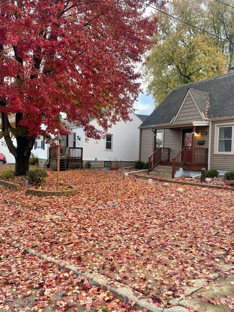 a backyard of a house with table and chairs