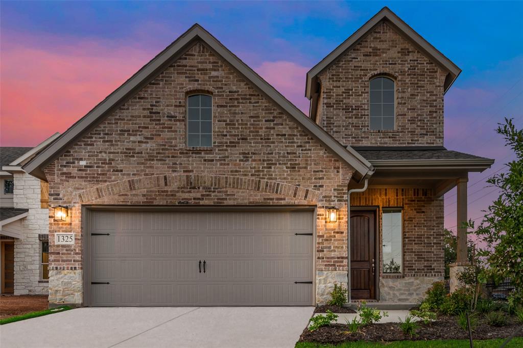 a front view of a house with garage