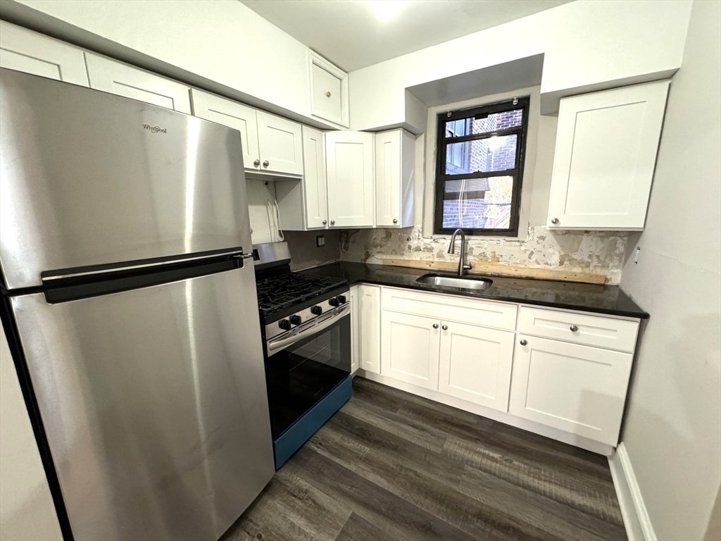 a kitchen with a refrigerator and a sink