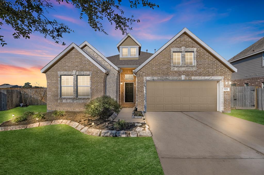 a front view of a house with a yard and garage