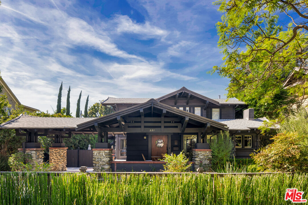 a front view of a house with a garden