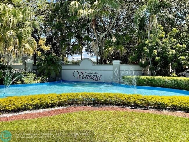 a view of swimming pool with a yard and large trees