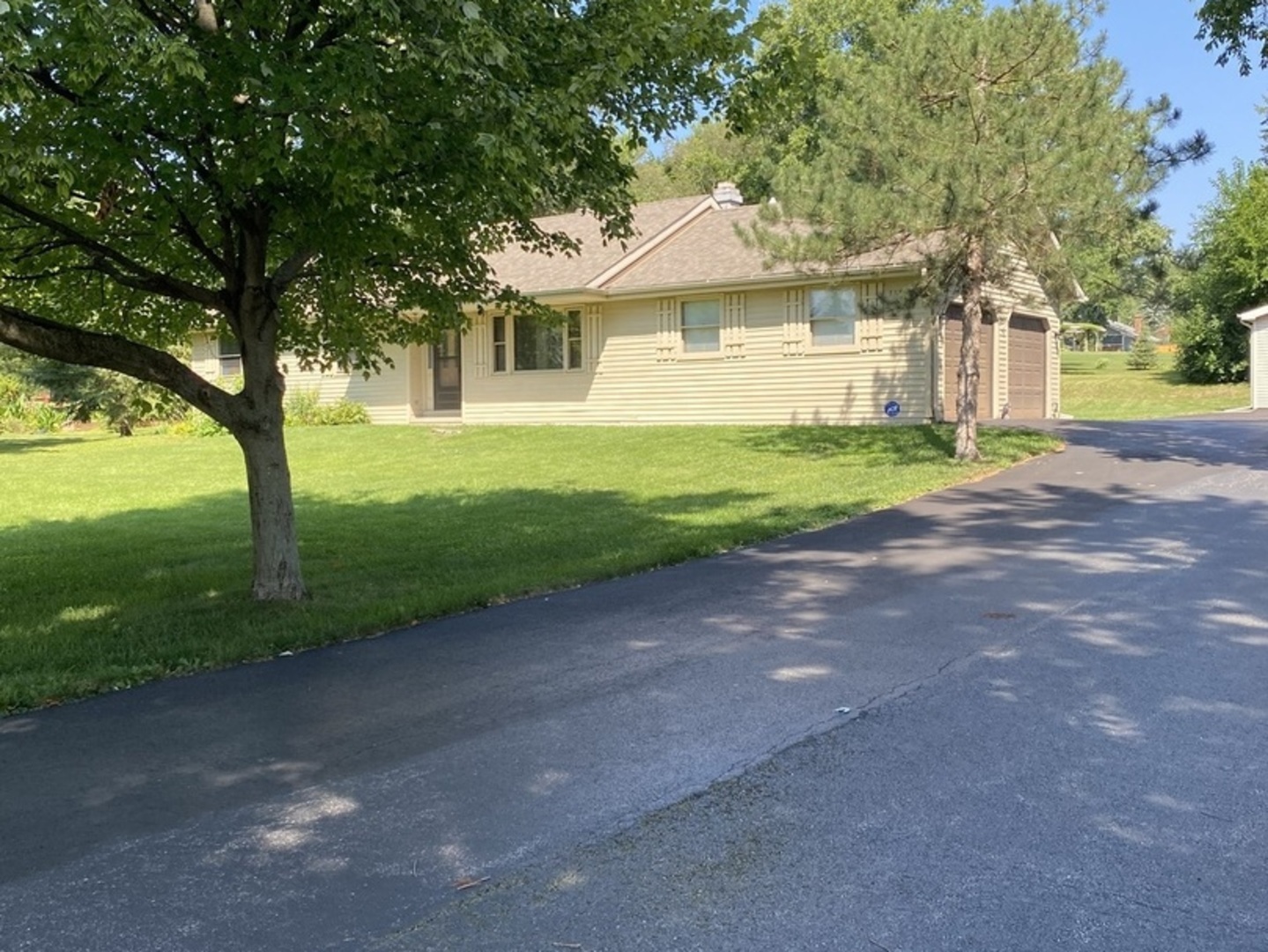 a front view of a house with a yard and a garage