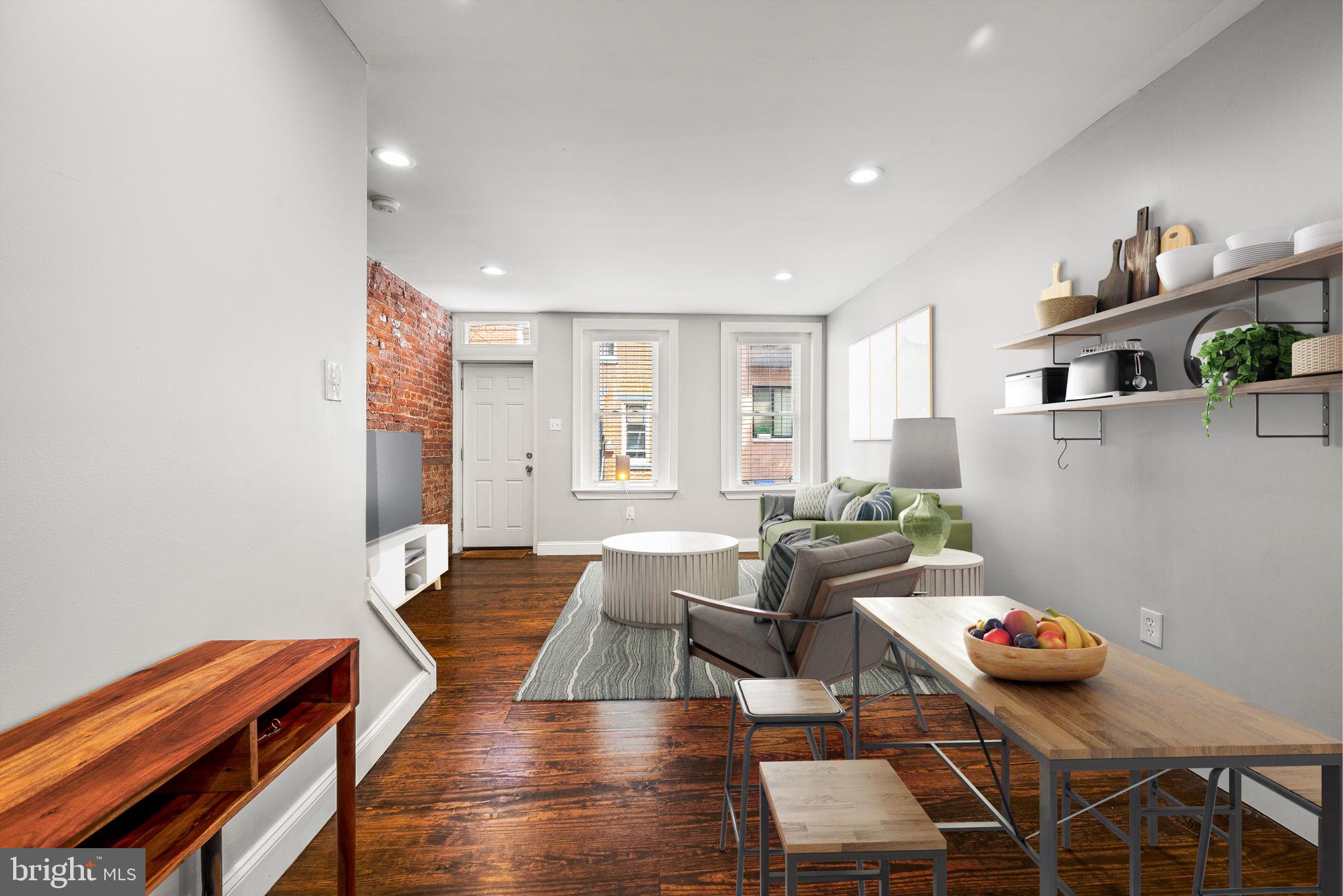 a living room with furniture and wooden floor