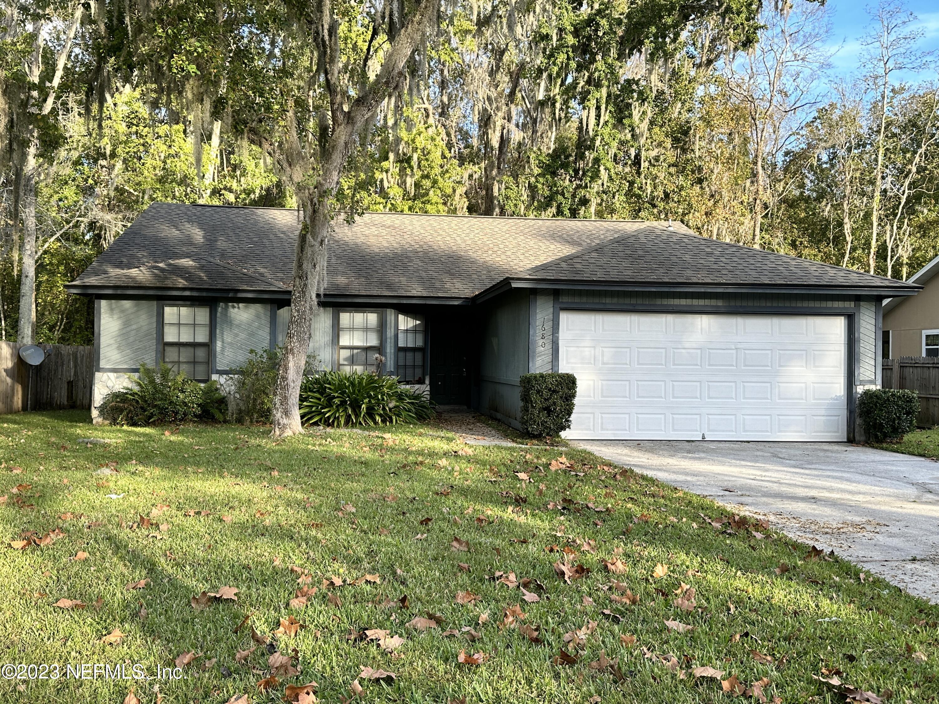 a front view of a house with a garden and yard